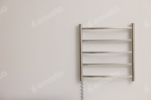 Preview: Heated towel rail on white wall, space for text