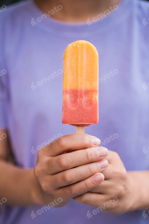 Preview: Hands holding colorful ice cream. Tasty dessert