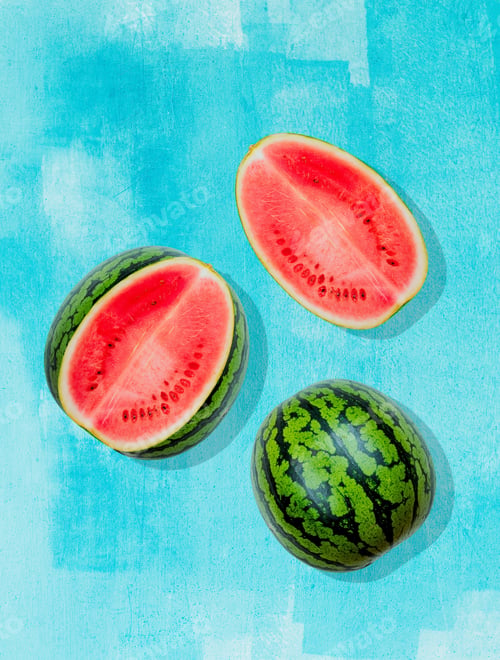 Preview: Watermelon on background painted in blue. Summer flat lay. Fresh juicy fruit