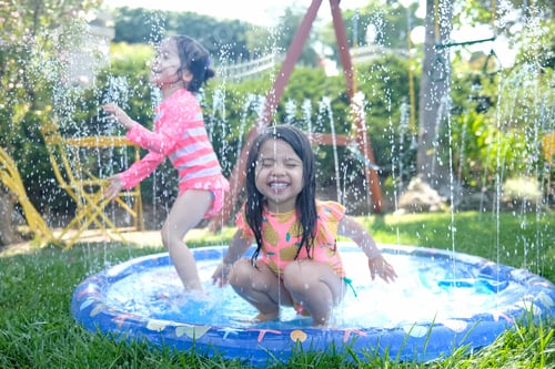 Preview: Children playing with water in the backyard during summer