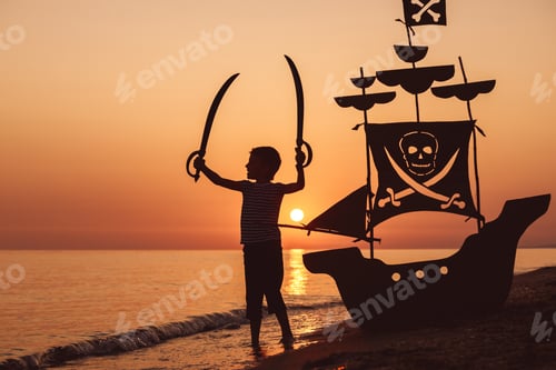 Preview: One happy little boy playing on the beach at the sunset time.