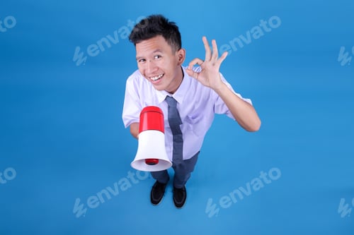 Preview: Indonesian Student Boy Wearing Uniform Holding a Megaphone While Showing Okay Sign