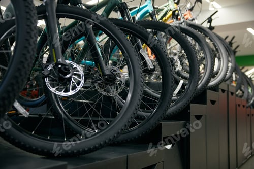 Preview: Mountain bike on rack showcase in shop closeup on bicycle wheels