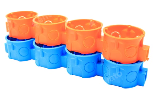 Preview: Stack of orange and blue electrical boxes. White background