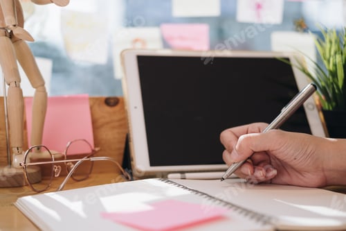 Preview: Close up of woman or accountant hand holding pen working on laptop computer for calculate business