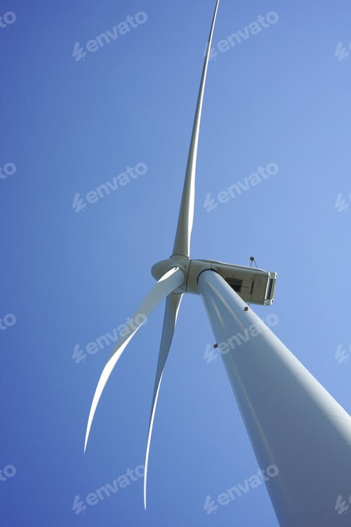 Preview: Windmill in the blue sky. Sustainable energy, wind energy. Windmil directly from beneath.