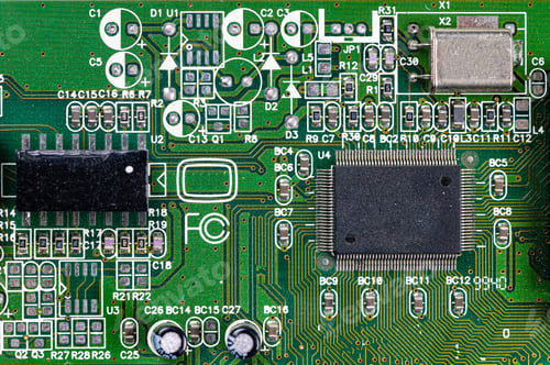 Preview: closeup shot of microchip on green printed circuit board, computer motherboard with components