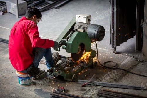 Preview: The worker is welding a steel frame in the workshop.