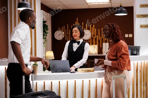 Preview: Employee talking to guests in hallway