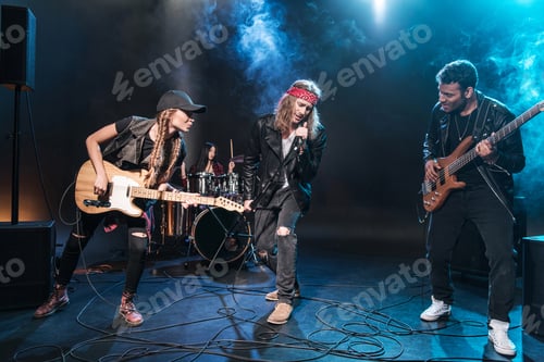 Preview: Handsome singer with rock and roll band performing music on stage