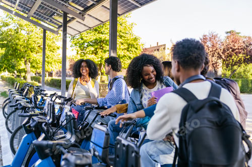 Preview: Multiracial students interacting at shared electric bike station