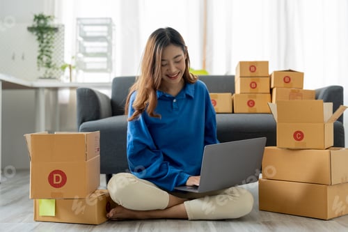 Preview: Startup SME small business entrepreneur, holding card box standing at her home office. Beautiful
