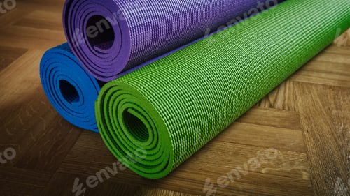 Preview: Colorful Yoga Mats Rolled Up on Wood Floor