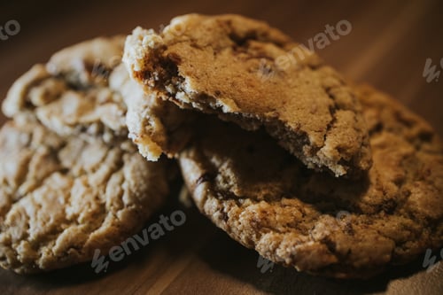 Preview: Close-up shot of fresh chocolate chip cookies on the wooden table background
