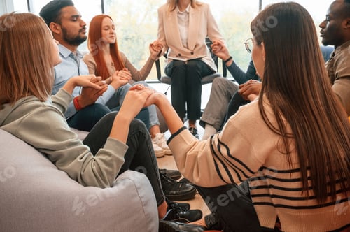 Preview: Holding hands. Group of people are having therapy meeting together