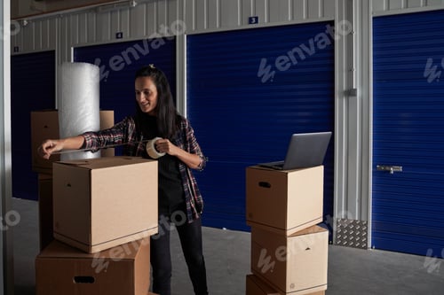 Preview: Woman packing box with scotch tape