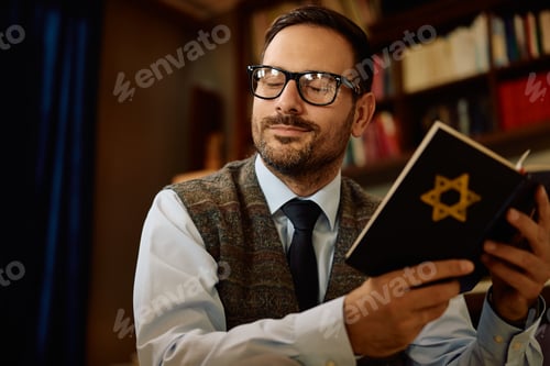 Preview: Jewish man reading Hebrew bible at home.