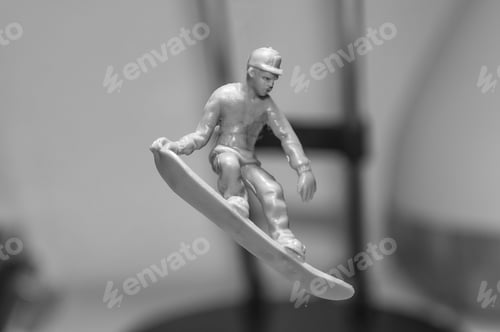 Preview: Small figurine of a surfer riding a board on a gray background