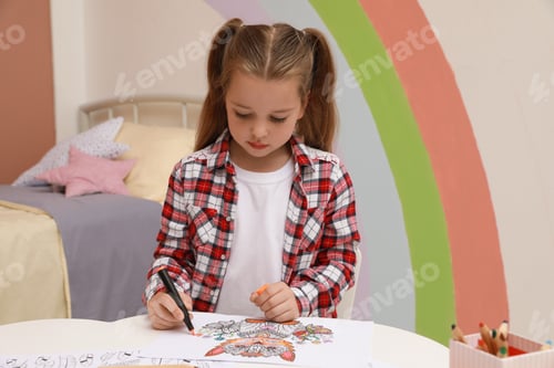 Preview: Little girl coloring antistress page at table indoors