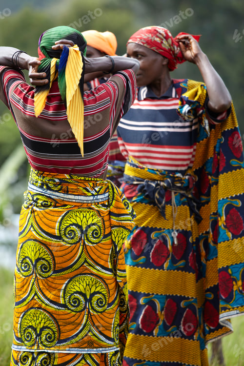 Preview: Two women in traditional African attire enjoying the outdoors together.