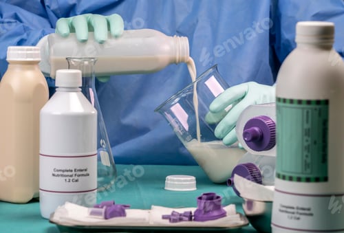 Preview: Nurse filling bottle supply in team of enteral nutrition