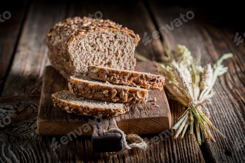 Preview: Homemade and fresh bread with whole grains on wooden table