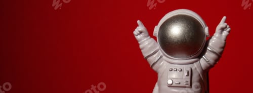 Preview: Plastic toy astronaut on colorful red background Copy space. Concept of out of earth travel, private