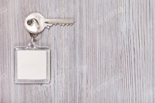 Preview: key with key chain on wooden background