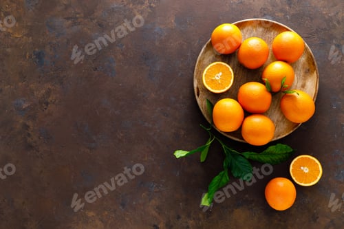 Preview: Oranges with leaves on dark background, top view