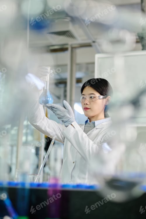 Preview: Young woman in lab coat and eyeglasses