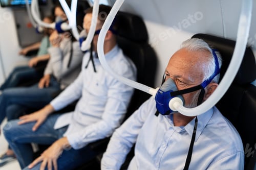 Preview: Senior patient breathing through mask during hyperbaric oxygen therapy.