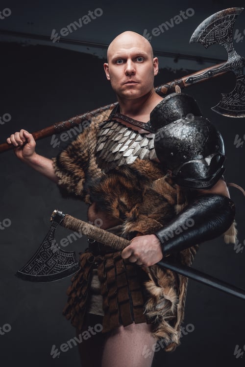 Preview: Hairless ancient warrior holding axes against dark background