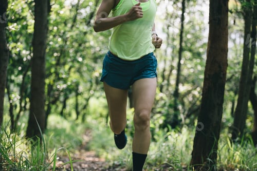 Preview: Fitness woman trail runner running in summer forest trail