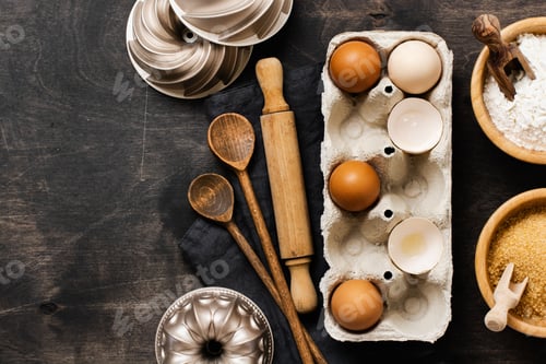 Preview: White and yellow chicken eggs and shells in an old cellulose vintage container with flour, sugar, wo