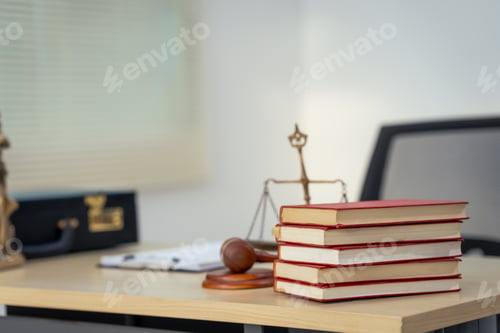 Preview: A lawyer's desk with no people present, featuring a law book, wooden gavel, old scales, a chair,