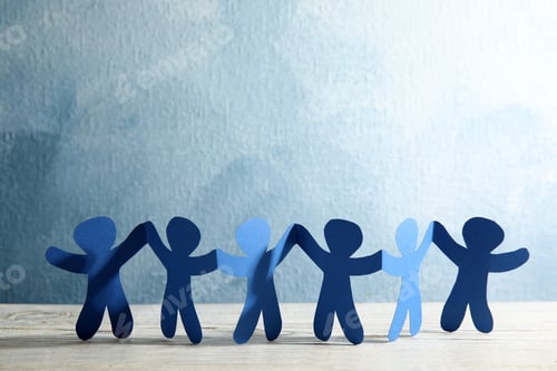 Preview: Paper people holding hands on wooden table. Unity and help concept