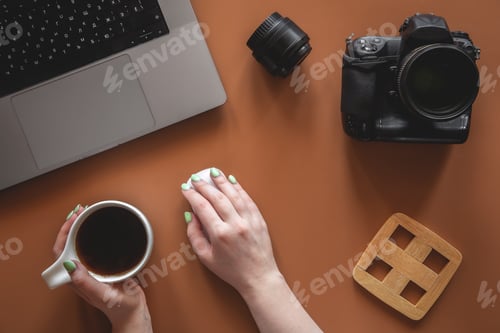 Preview: Photographer's workplace with camera and lens, flat lay.
