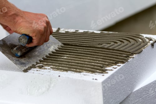 Preview: Close-up of worker hand with trowel applying glue
