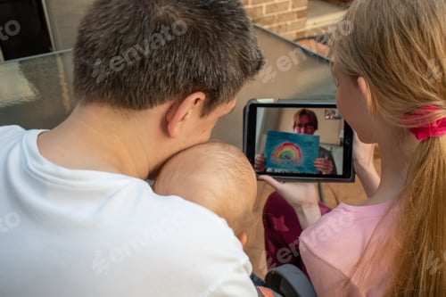 Preview: Family video chat - a man with two children using tablet for communication