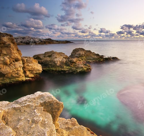 Preview: Tranquil Ocean View with Rocks and Clouds