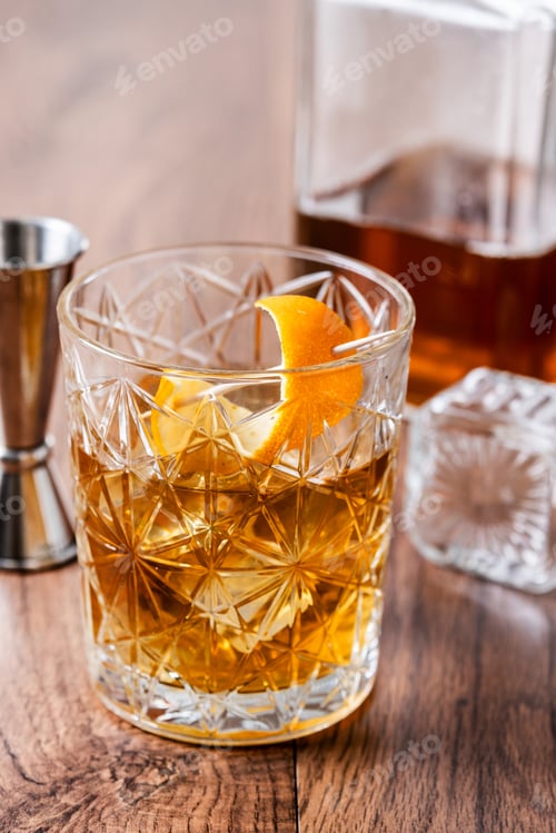 Preview: Old fashioned cocktail garnished with orange on wooden table