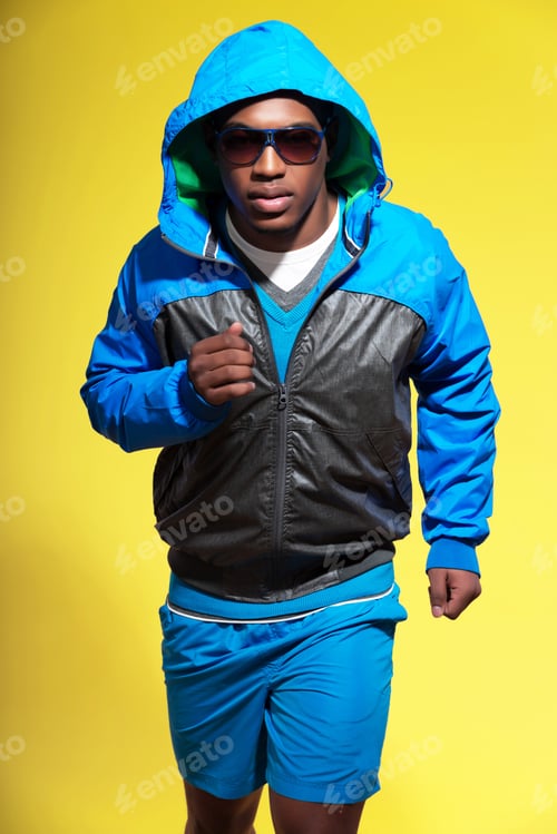 Preview: Athletic Black Man In Sportswear Fashion. Runner With Hoody Jacket And Sunglasses. Intense Colors