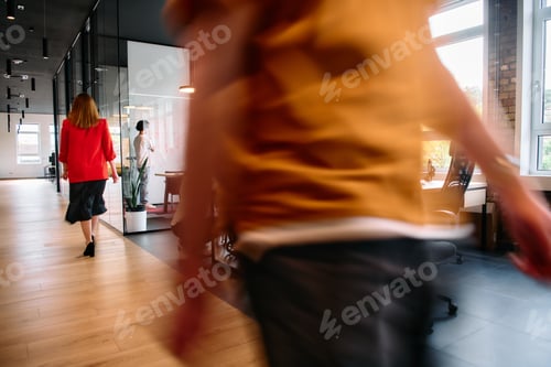 Preview: A diverse group of business professionals collaborates in a modern startup coworking center