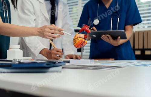Preview: Doctors Team Explaining Human Heart Anatomy Using Cardiovascular Model in Medical Office.