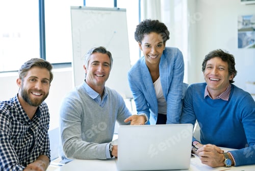 Preview: A group of businesspeople sitting with a laptop in the boardroom