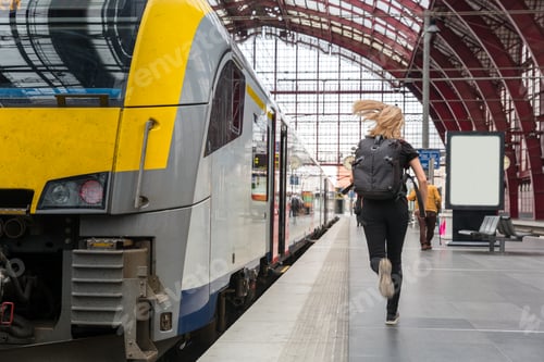 Preview: Female tourist with backpack running to the train