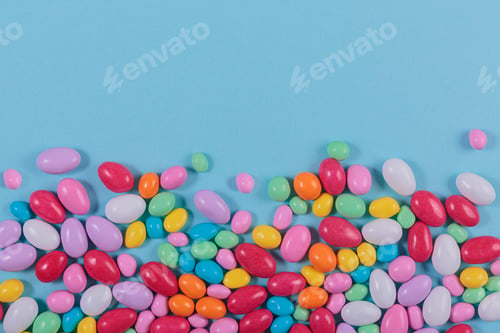Preview: Delicious chocolate colorful coated candy on blue background
