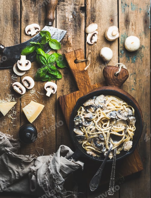 Preview: Mushroom pasta spaghetti in iron pan served with parmesan, basil