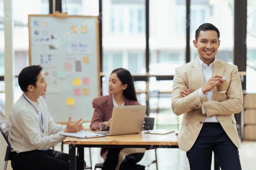 Preview: Portrait of happy and confident young man against background of his business team colleagues