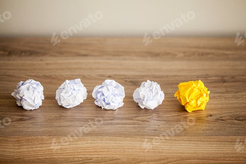 Preview: Great idea concept. Crumpled colorful paper on wooden table